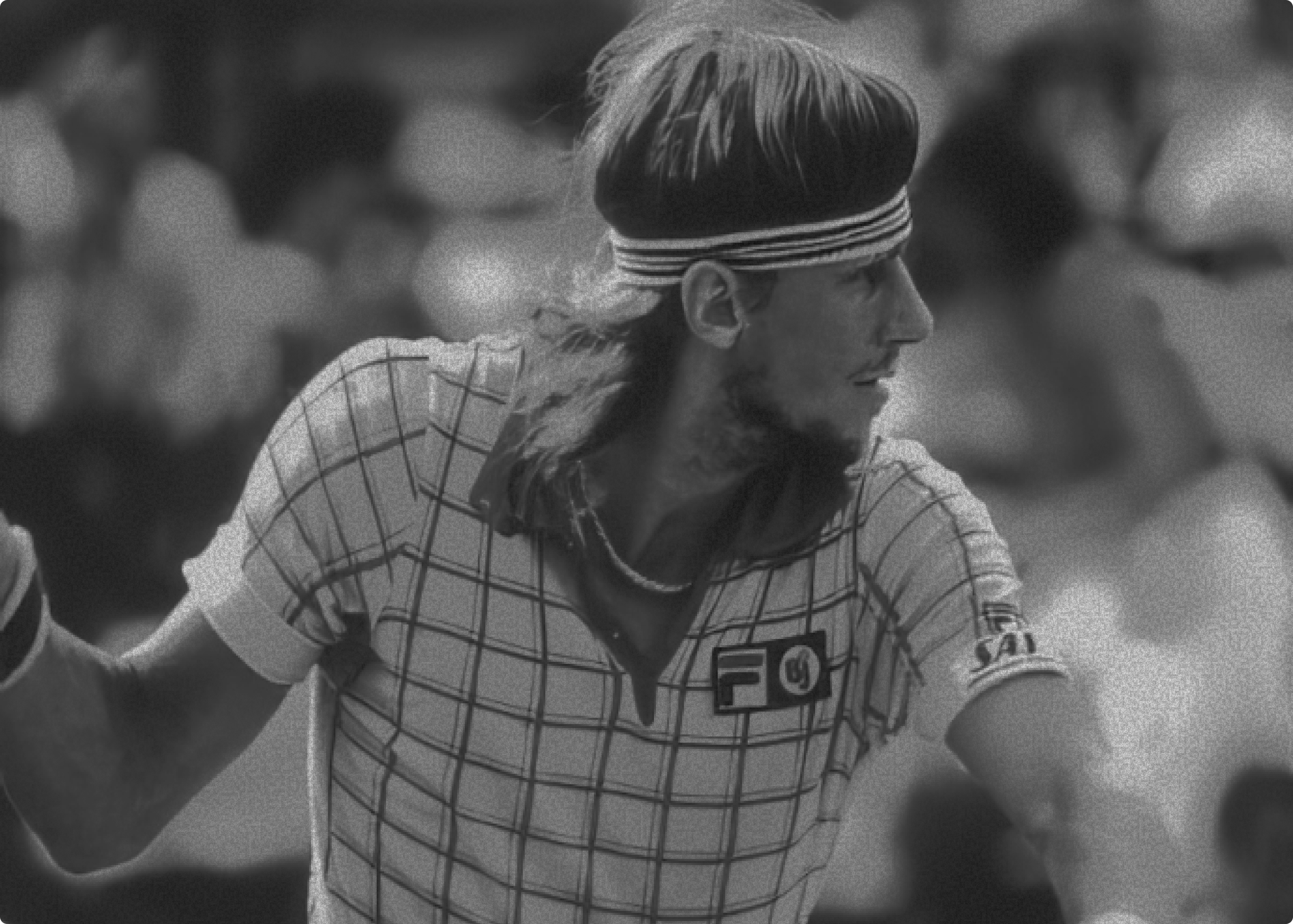 Two women sitting at a modern table talking with a city view behind them.