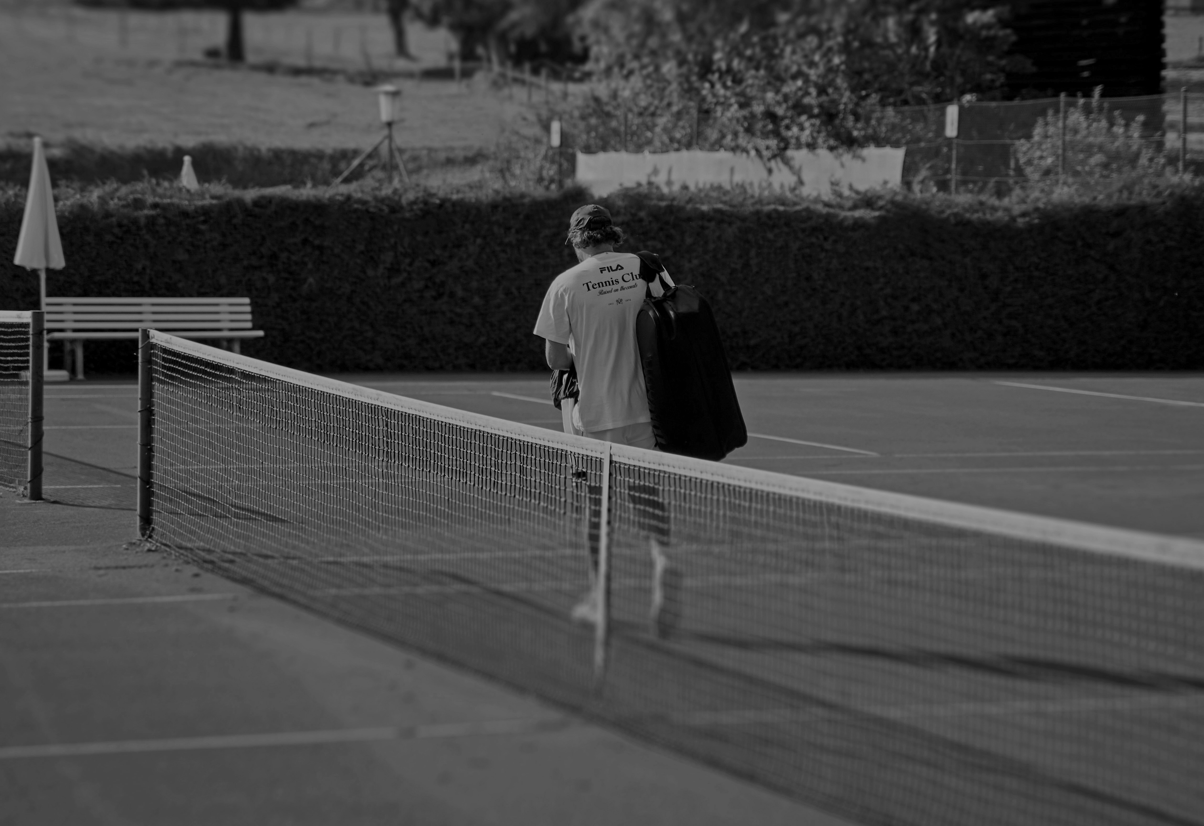 Two women sitting at a modern table talking with a city view behind them.