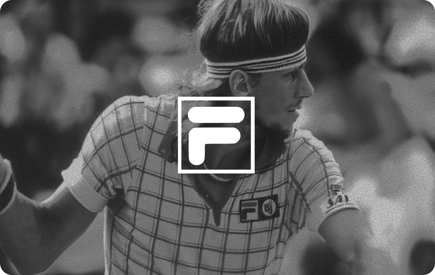 Two women sitting at a modern table talking with a city view behind them.